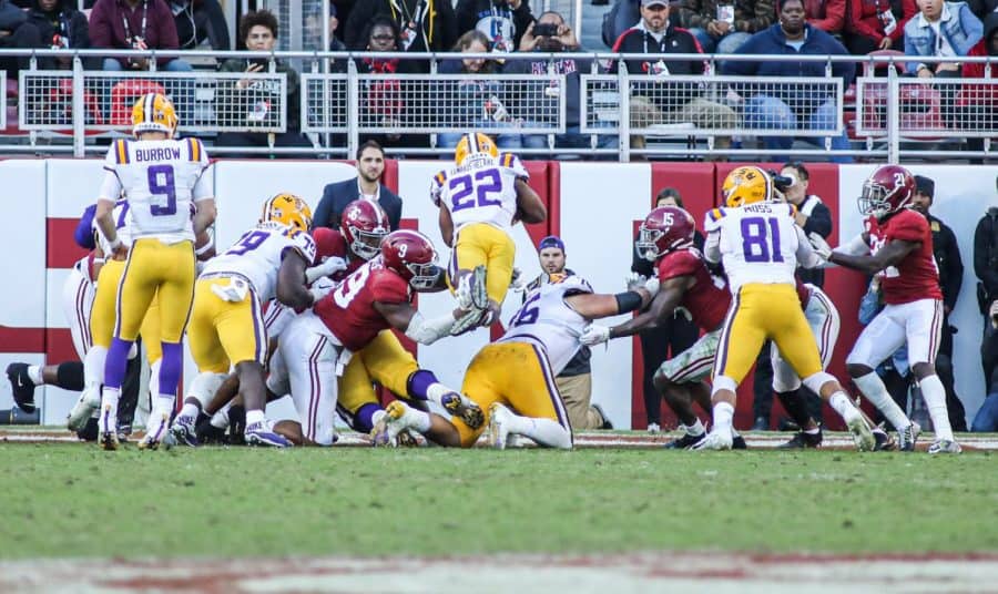 LSU running back Clyde Edwards-Helaire dives over the goal line for his first of four touchdowns. He is the first player with four touchdowns against Alabama in the Nick Saban era. (CW / Joe Will Field)