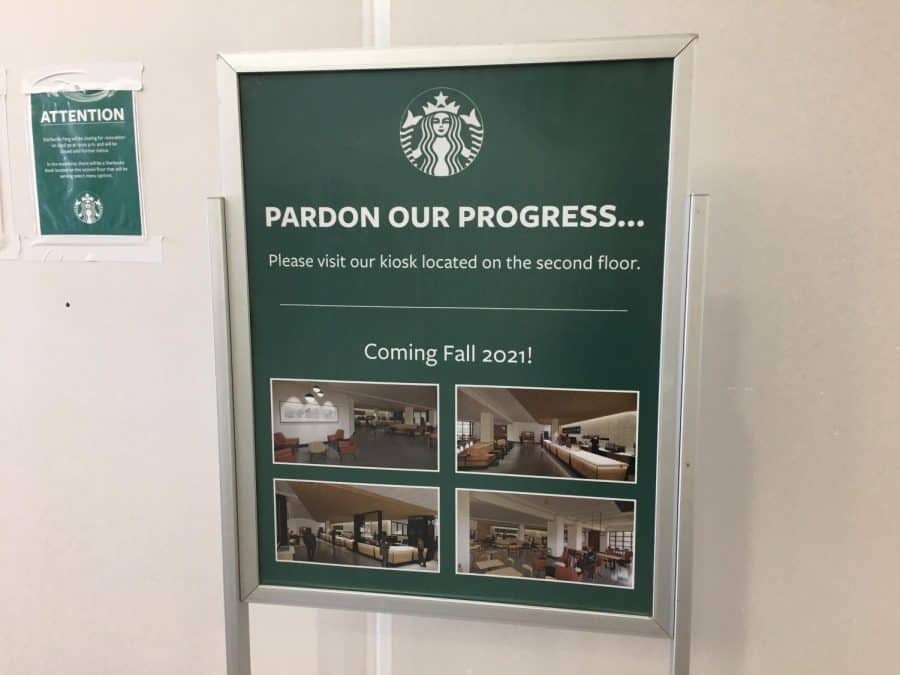 A sign posted by Starbucks featuring images of the planned remodel, as well as the following text: Pardon our progress... Please visit our kiosk located on the second floor. Coming Fall 2021!