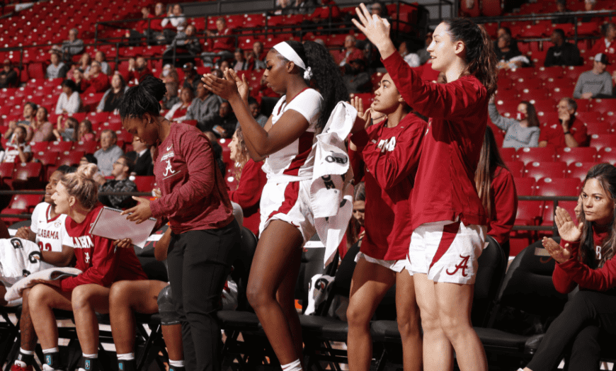 Alabama womens basketball players celebrate after a three-pointer by guard Hannah Barber to regain the lead late in the third quarter during Sundays game.