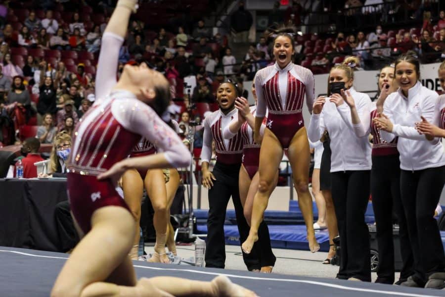 The Alabama gymnastics team rejoices as senior Shallon Olsen completes her floor routine on Feb. 4, 2022.