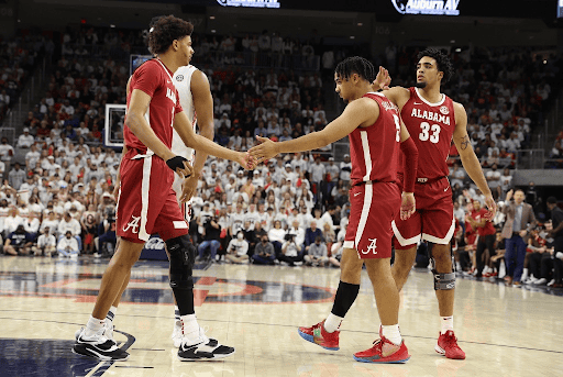 Alabama players Darius Miles (2), Jaden Shackelford (5) and James Rojas (33) console each other in Alabama’s 100-81 loss at No. 1 Auburn on Feb. 1, 2022.