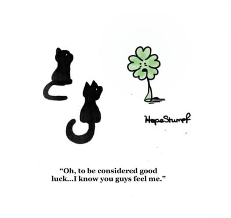 A five leaf clover is speaking to two black cats. It says, oh, to be considered good luck... I know you guys feel me.